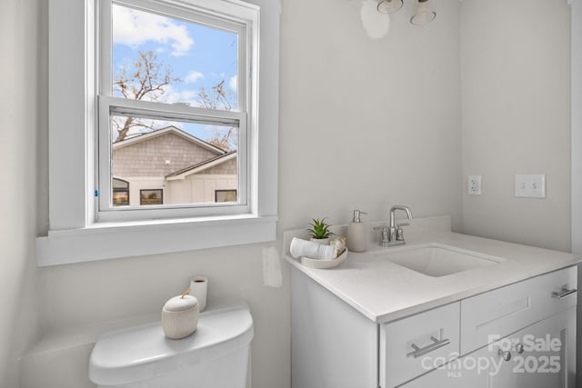 bathroom featuring vanity and toilet