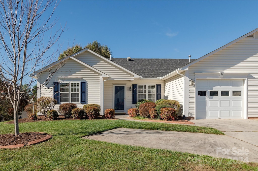 ranch-style house with a garage and a front yard