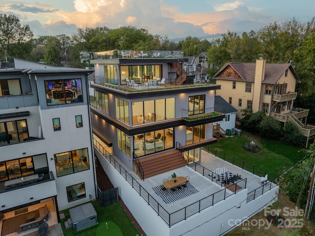 back house at dusk with a patio