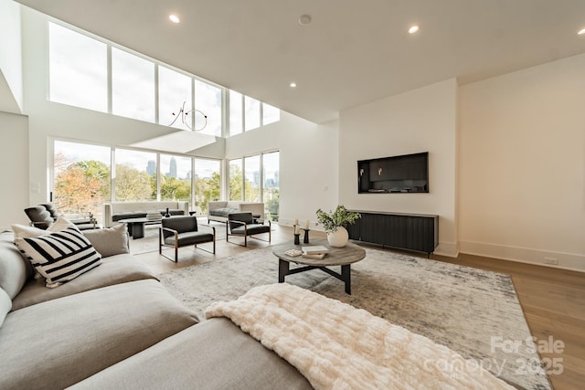 living room featuring light hardwood / wood-style floors and a high ceiling