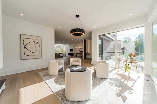 living room featuring light wood-type flooring and a wealth of natural light