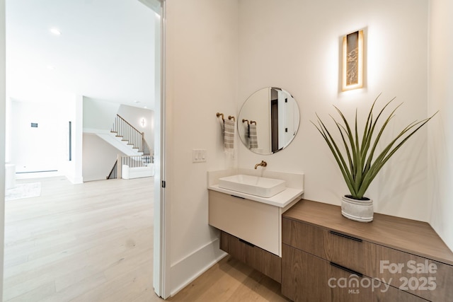 bathroom with vanity and wood-type flooring