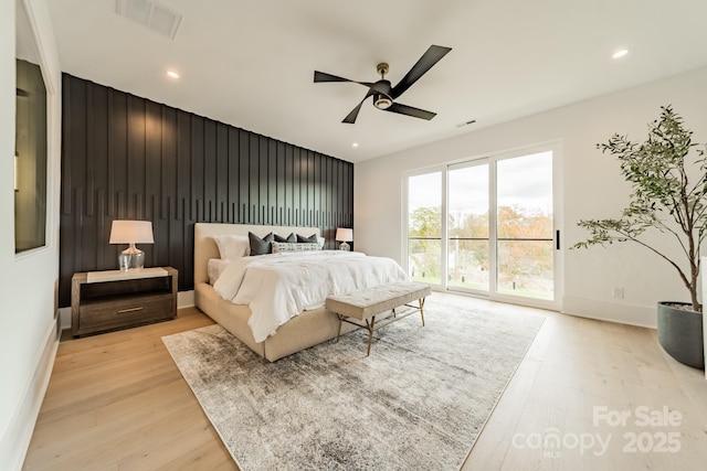 bedroom with access to exterior, light hardwood / wood-style floors, and ceiling fan