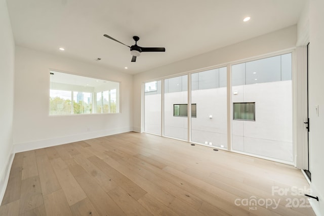 spare room with ceiling fan and light hardwood / wood-style flooring