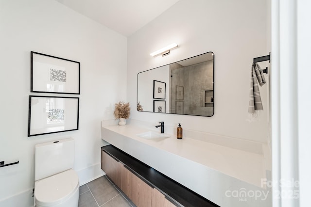 bathroom with tile patterned flooring, vanity, and toilet