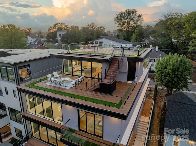 view of back house at dusk