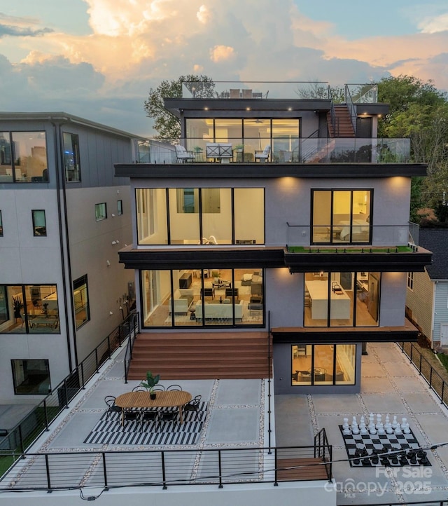 view of back house at dusk