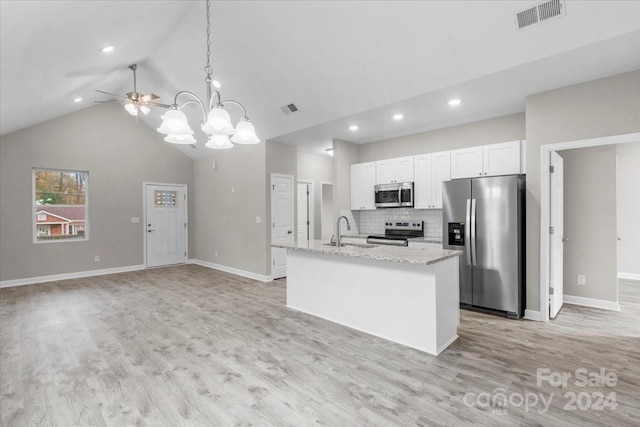 kitchen featuring an island with sink, white cabinets, stainless steel appliances, and light wood-type flooring