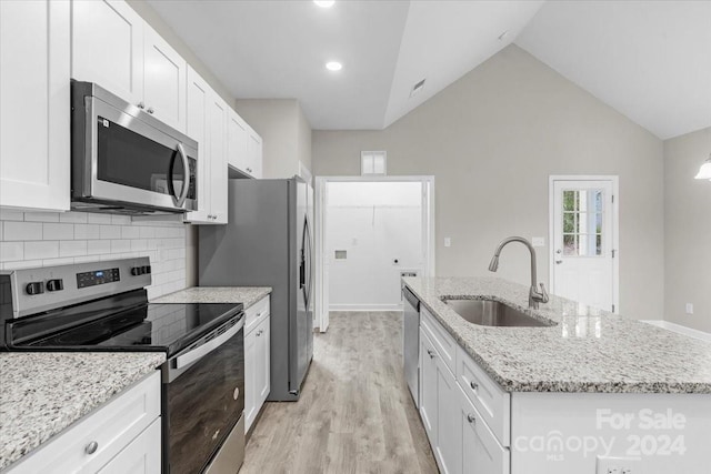 kitchen featuring white cabinetry, a kitchen island with sink, sink, and stainless steel appliances