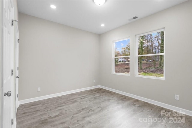 spare room with light wood-type flooring