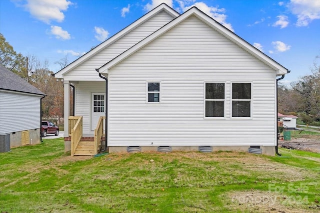 rear view of property with a yard