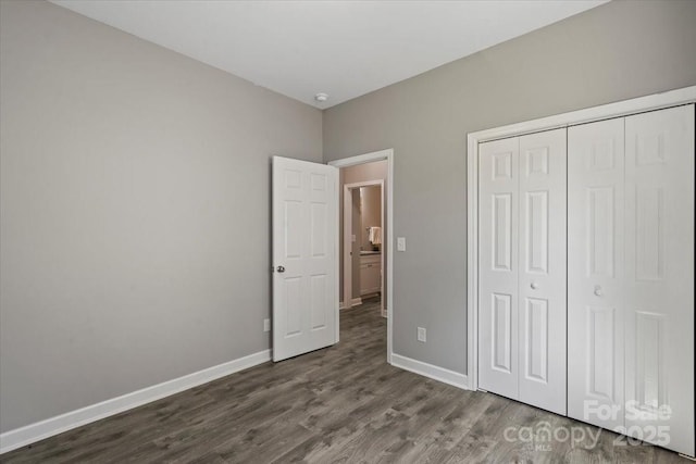 1105 Kenly St, Salisbury, NC 28144 - unfurnished bedroom with a closet, baseboards, and dark wood-type flooring