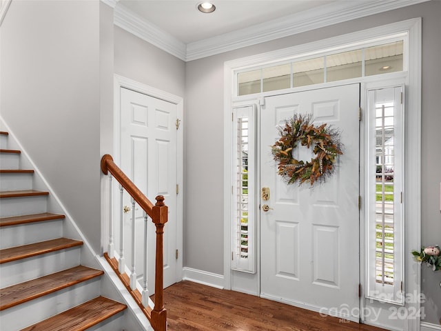 foyer entrance with dark hardwood / wood-style floors and crown molding