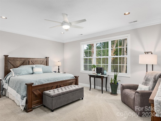 bedroom featuring ceiling fan, crown molding, and light colored carpet