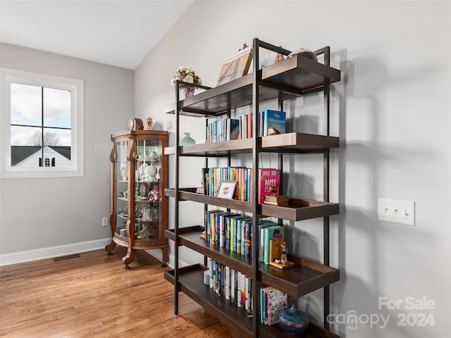 interior space with hardwood / wood-style flooring and lofted ceiling