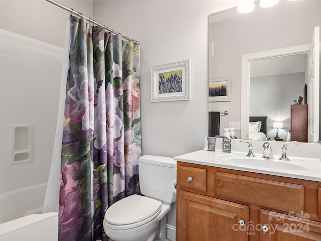 full bathroom featuring vanity, shower / bath combination with curtain, and toilet