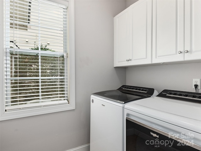 laundry area featuring independent washer and dryer and cabinets