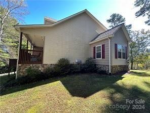 view of side of property with a yard