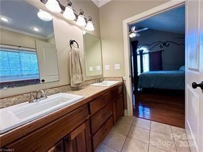 bathroom featuring vanity, wood-type flooring, and ornamental molding