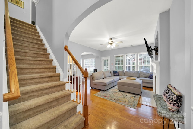 living room with hardwood / wood-style flooring and ceiling fan