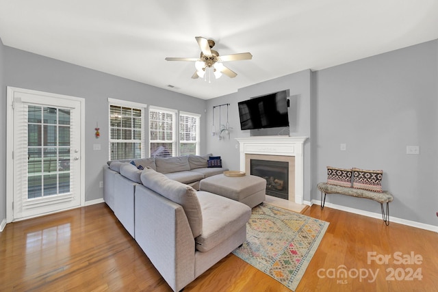 living room with wood-type flooring and ceiling fan