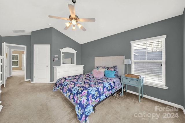 bedroom featuring multiple windows, ceiling fan, and lofted ceiling