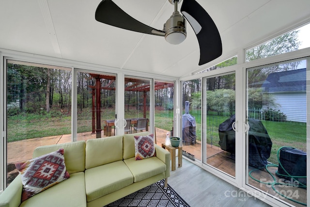 sunroom featuring vaulted ceiling and ceiling fan