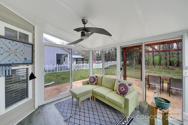 sunroom featuring ceiling fan