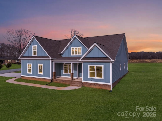 view of front of house with a yard and covered porch