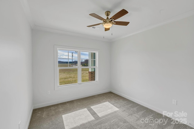 carpeted empty room with ceiling fan and ornamental molding