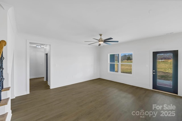 unfurnished living room with dark hardwood / wood-style floors and ceiling fan