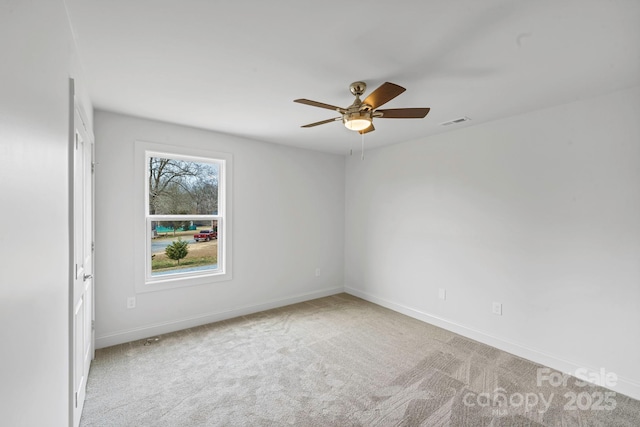 unfurnished room featuring ceiling fan and light carpet