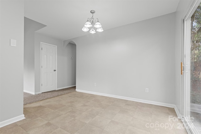 spare room featuring a notable chandelier