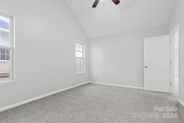 unfurnished room with ceiling fan, carpet floors, and vaulted ceiling