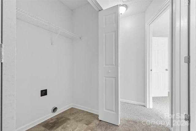 clothes washing area with electric dryer hookup and light colored carpet