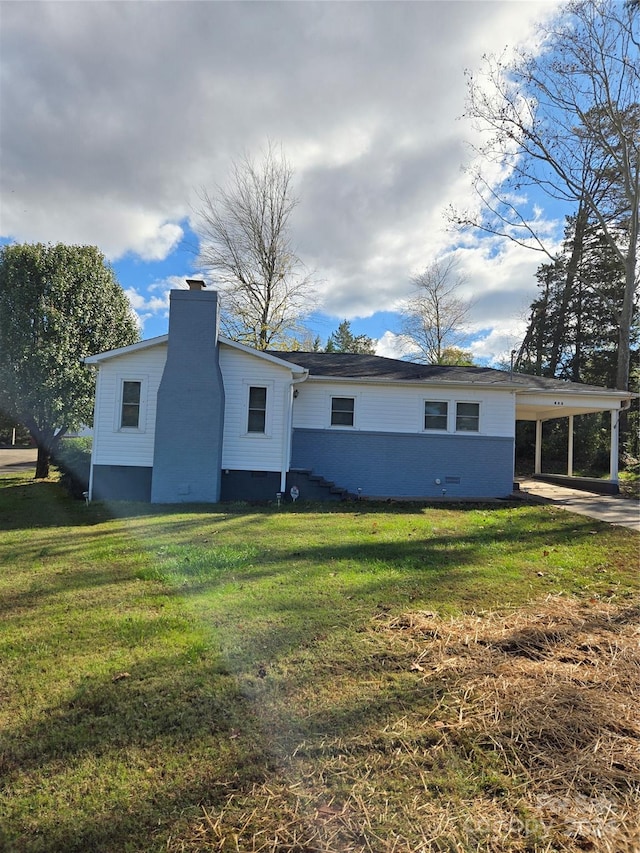 rear view of house with a yard and a carport