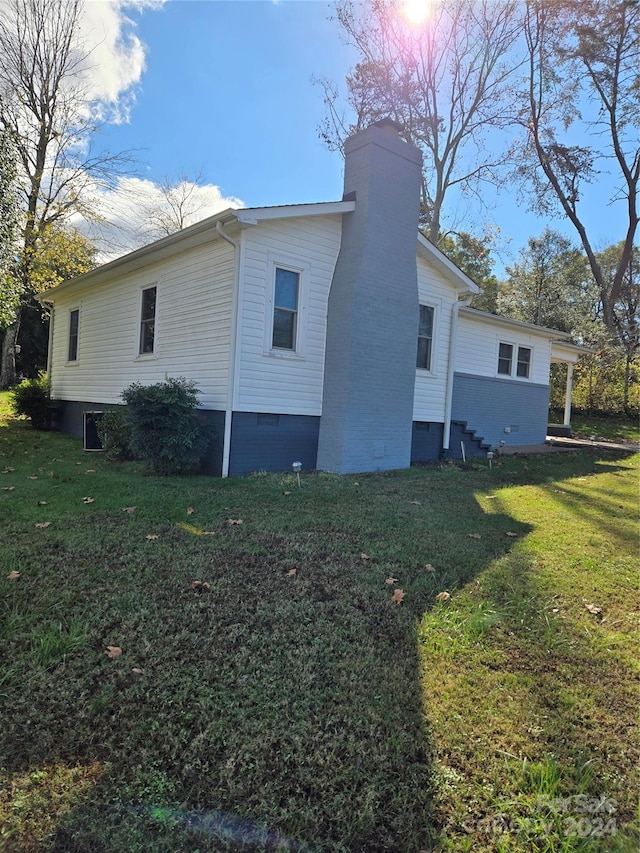 view of side of property with a lawn