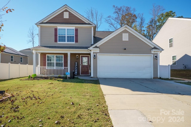 view of front of house with a front yard, a porch, and a garage