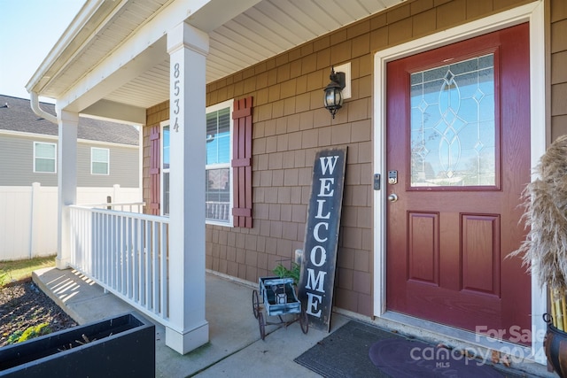 view of exterior entry with a porch