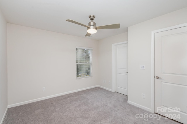 unfurnished bedroom featuring ceiling fan and light colored carpet