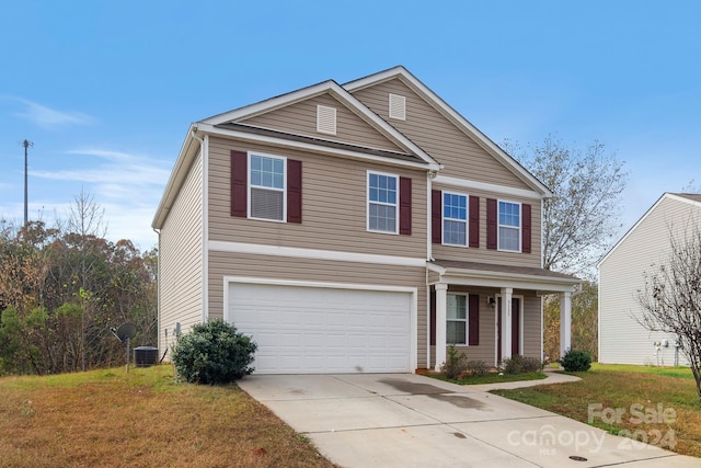 view of front of home featuring a front yard and a garage