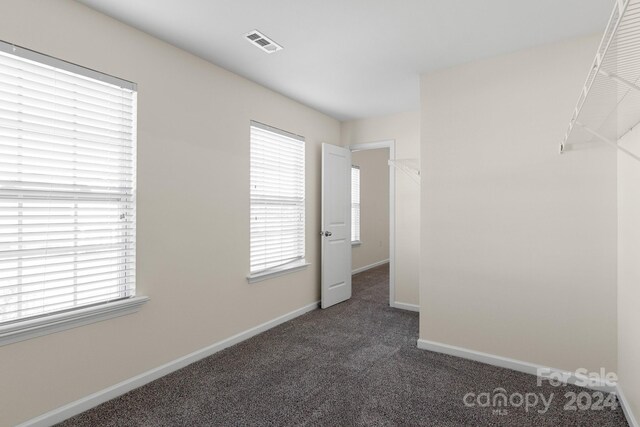 empty room featuring dark carpet