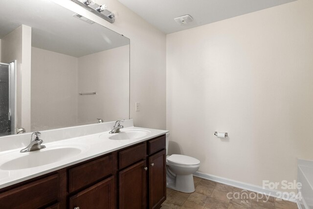 full bathroom featuring vanity, toilet, and shower with separate bathtub