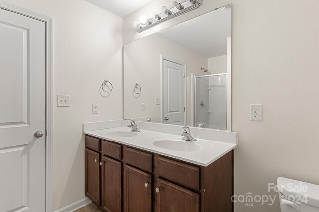 bathroom featuring toilet, an enclosed shower, radiator, and vanity