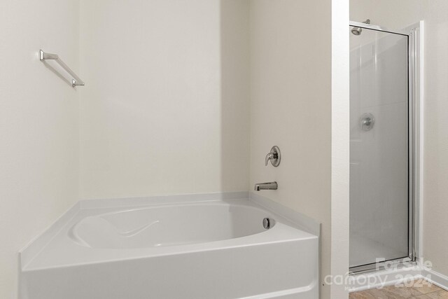 bathroom featuring tile patterned floors and a bathtub