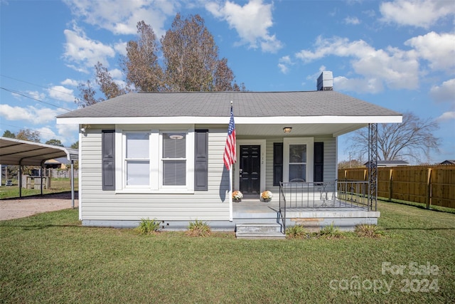 view of front of house featuring a carport, a porch, and a front yard