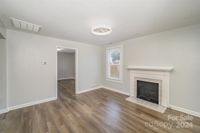 unfurnished living room featuring a fireplace and hardwood / wood-style floors