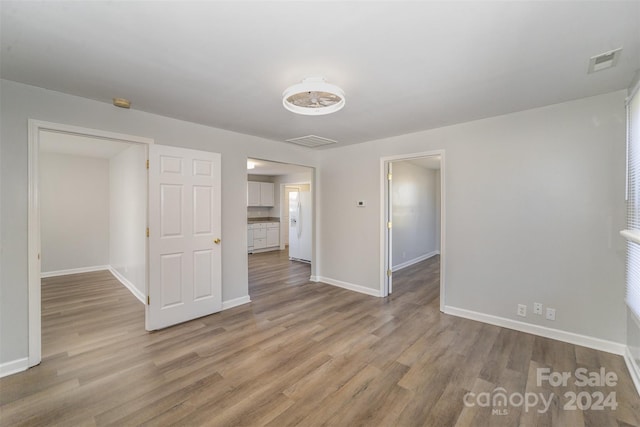 unfurnished room with light hardwood / wood-style floors