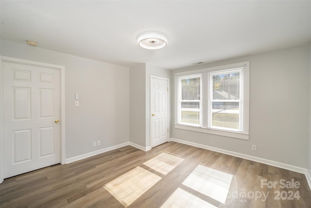 unfurnished room with hardwood / wood-style flooring