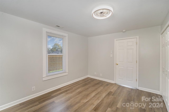 unfurnished room featuring wood-type flooring